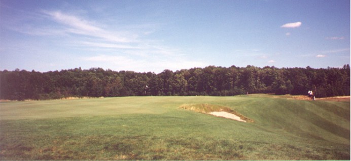 This view from the back-left of the 13th green shows the 'safe' play to the left off the tee leaves no bargain of a chip shot.  The bunker in the foreground dominates play when the hole is in the narrow rear neck of the green.