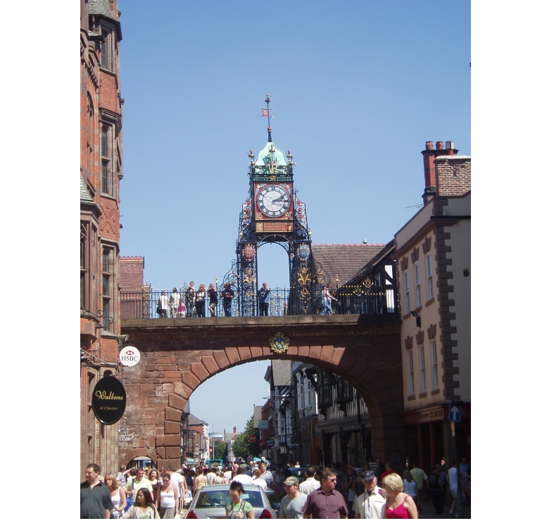  Visitors, walking the walls of Chester, look down on shoppers in Eastgate Street. The clock was erected for Queen Victoria's Silver Jubilee in 1897. 