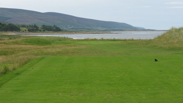 The ninth green, complete with sheep fence, hard by the shore.