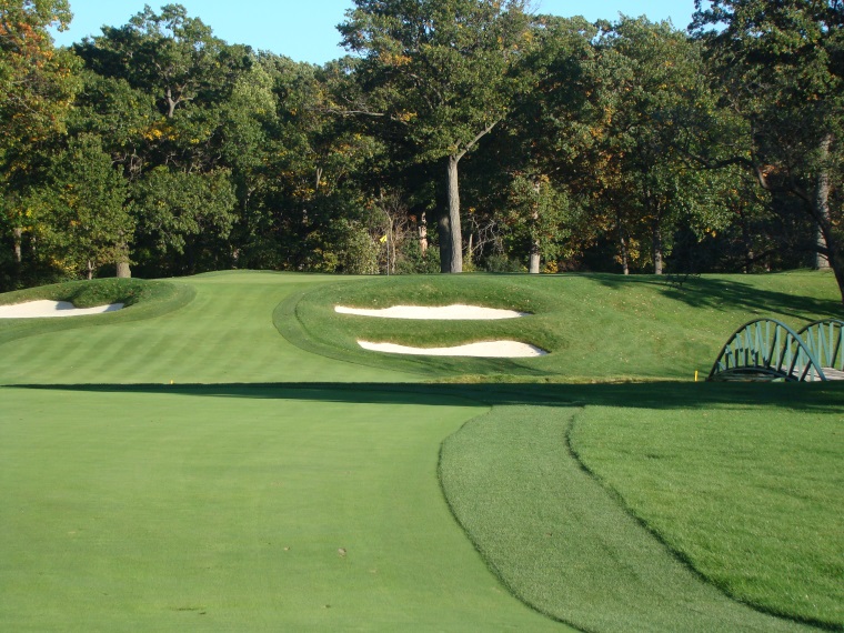 Ideally, the approach to the elevated green is played from a level lie in the fairway.