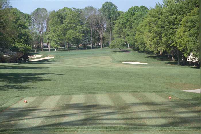 A benign tee shot is followed by a demanding second shot to a large green where placement is key. Any lofted shot that lands into the crown fronting the green will not advance very far onto the green.