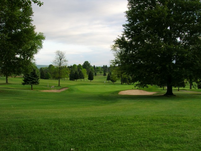 The push up ninth green from the right side of the fairway, showing the trouble a golfer can find with a sliced or pushed drive.