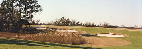 These bunkers determine the correct play for your second shot on the 14th.