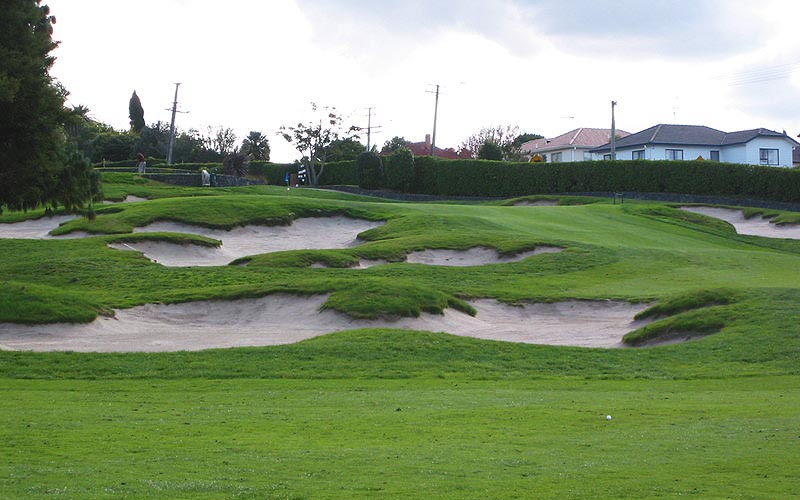 Bunkers on the inside of the dog-leg 18th hole, with the green just visible beyond.