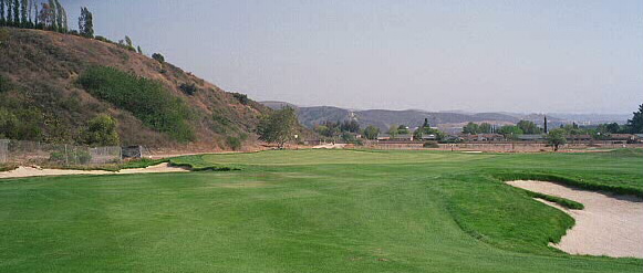 By driving left, the golfer has a simple pitch up the length of the green.