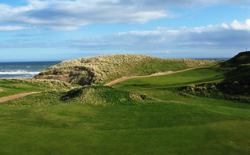 The view of the fifteenth green from the from the eighth hole shows the combination of wonderful land and natural setting that make Cruden Bay so special.