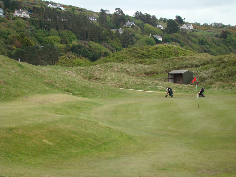 Tucked into the dunes, there are many ways to use the surrounding ground to approach this green.