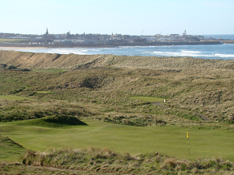 What a view looking back across the second green out toward Fraserburgh and Inverallochy! One of the hole's big fairway mounds is prominent left of the green. 