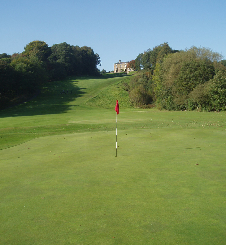 Reddish Vale is an unheralded design gem, especially for a course built by Alister MacKenzie and that features some of the most memorable holes in the game. In the foreground is the sixth green reached from 240 yards away from a tee high on the hill. The fairway that leads up to the clubhouse is the eighteenth whose steep grade is unmatched in golf. 