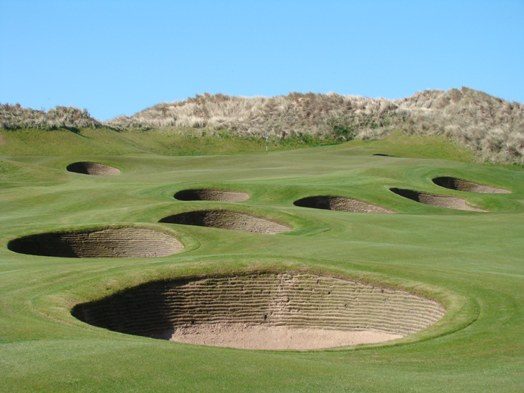 The cluster of bunkers found 20-90 yards from the green is a design theme repeated at both the first and eighteenth. Throw in playing into the wind and the third shost into all three of these par fives is likely to be longer here than what the golfer is accustomed.