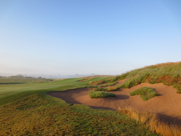 With the wetland to the left and this bunker to the right, the opening tee shot demands the player’s attention. As is also the case with lay-up seconds to the fourteenth and eighteenth holes, the second shot of the opener tests a player’s discipline as he needs to aim well away from the visible green.