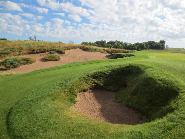 Bunkers come in all shapes and sizes at Erin Hills. On the 13th this small pit is paired with a sprawling erosion bunker.